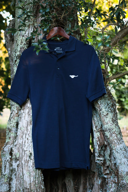 midnight-blue-biodegradable-pure-merino-wool-golf-polo-shirt-for men-by-snöleo.-hanging-in-olive-tree